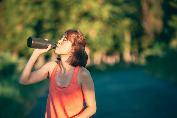 istock Asian woman exercising in the park 1273411106