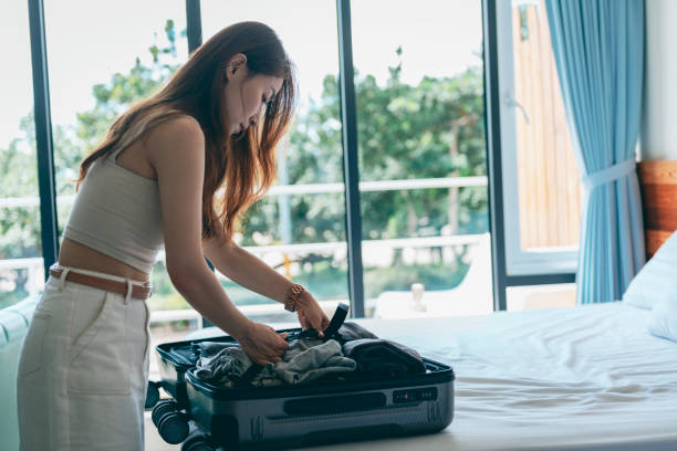 istock Woman packing suitcase 1273412138