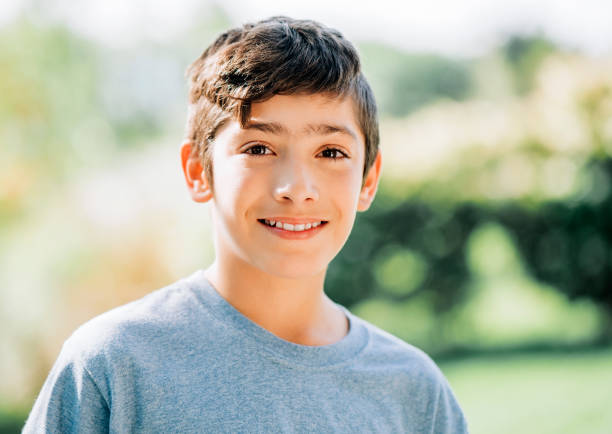 istock Cute smiling boy in backyard during sunny day 1273422746