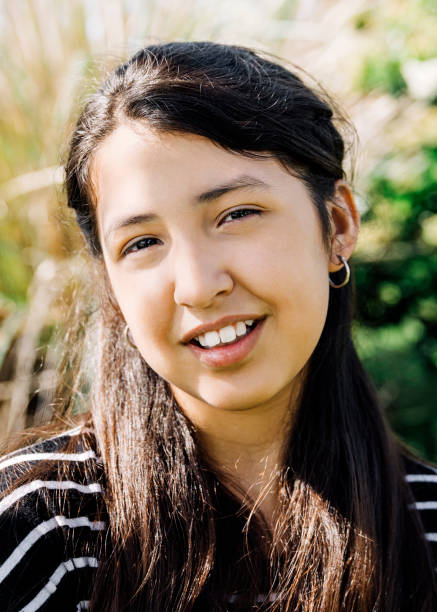 istock Smiling girl in backyard during sunny day 1273422800