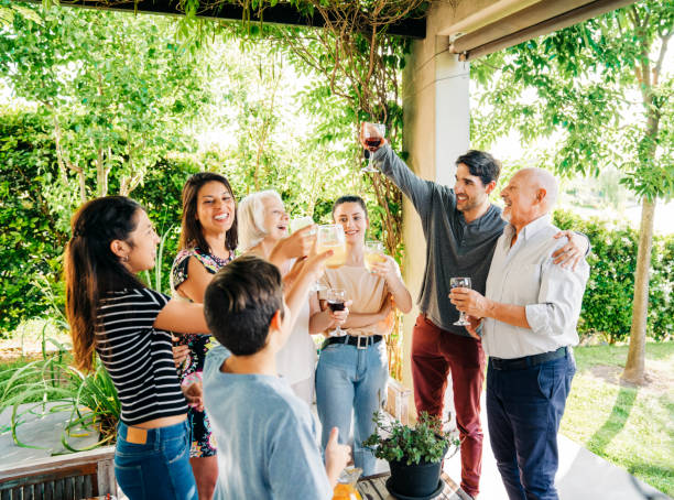 istock Happy family toasting drinks at patio 1273422882