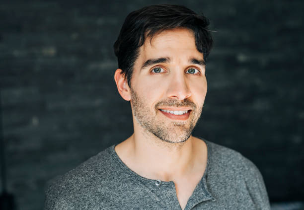istock Smiling handsome man at home 1273422897