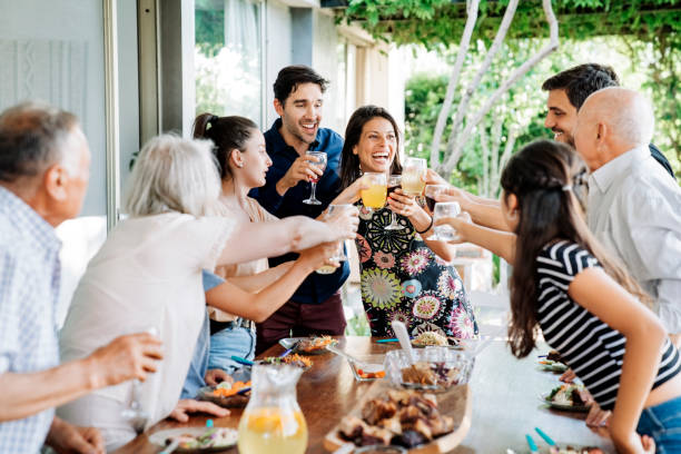 istock Cheerful family toasting drinks at patio 1273422912