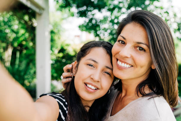 istock Smiling woman taking selfie with daughter 1273423557