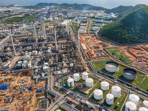 Aerial drone POV sunset view over crude oil refinery ,power plant or chemical factory in south east asia