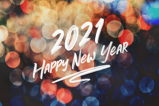 2021 happy new year brush stroke handwriting on abstract festive colorful bokeh light background,holiday greeting card