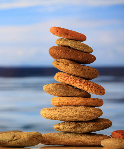 istock Zen stones stack on blue sky and sea background 1273432231
