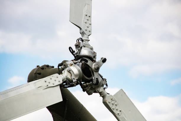 Vintage Charm: The Weathered Rotors of a Yellow Old Helicopter Unveil Aviation History