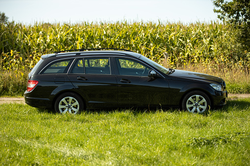 Hamburg, Germany . September 18. 2020: Mercedes c class t model, production period_2007 to 2014. side view parked in the country on a meadow. In the background a corn field, in Hamburg, Germany.  No people in this picture
