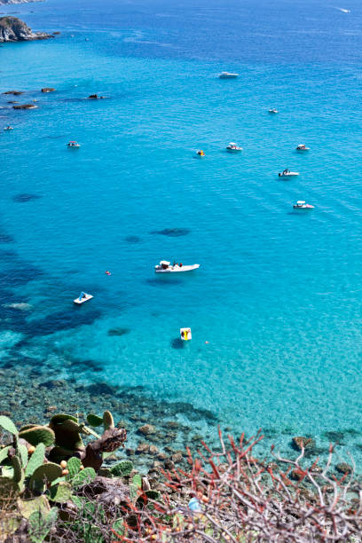 istock Boats near a rock stone coast. 1273439688