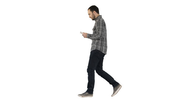 istock Confident serious man walking and working in tablet on white bac 1273440043