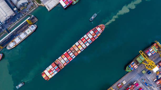 istock Container ship carrying container boxs in import and export business commercial logistic and freight shipping transportation by container ship, Container loading cargo ship, Aerial top view. 1273440912
