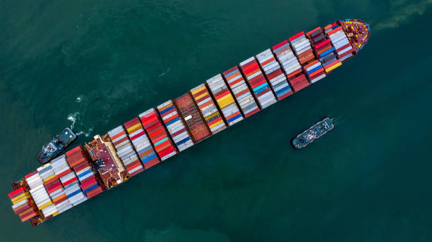 istock Container ship carrying container boxs in import and export business commercial logistic and freight shipping transportation by container ship, Container loading cargo ship, Aerial top view. 1273440915