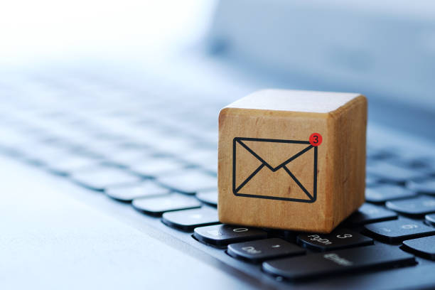 istock An envelope symbol on a wooden cube on a computer keyboard, with a blurred background and shallow depth of field. 1273441852