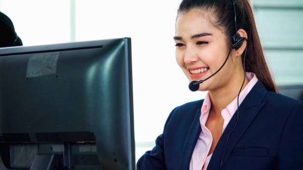 istock Business people wearing headset working in office 1273442724