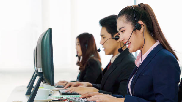 istock Business people wearing headset working in office 1273442786