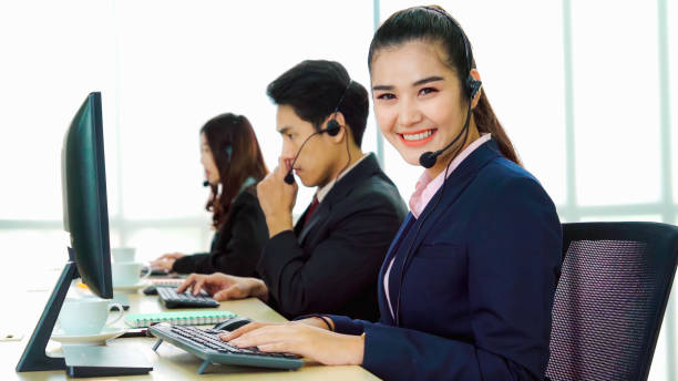 istock Business people wearing headset working in office 1273442963