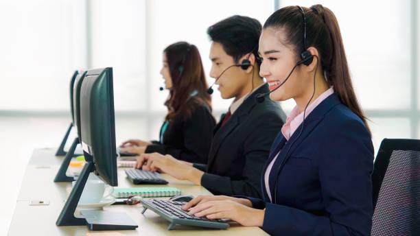 istock Business people wearing headset working in office 1273443735