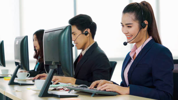 istock Business people wearing headset working in office 1273443871