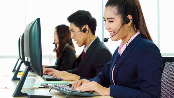 istock Business people wearing headset working in office 1273444148