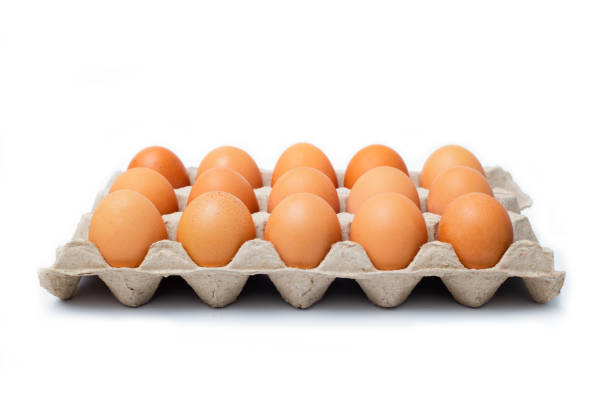 istock Close-up view of raw chicken eggs on white background. 1273445293