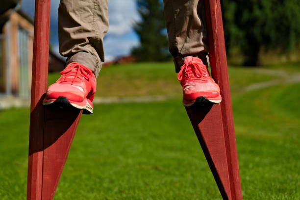 Person walking on traditional stilts in a park