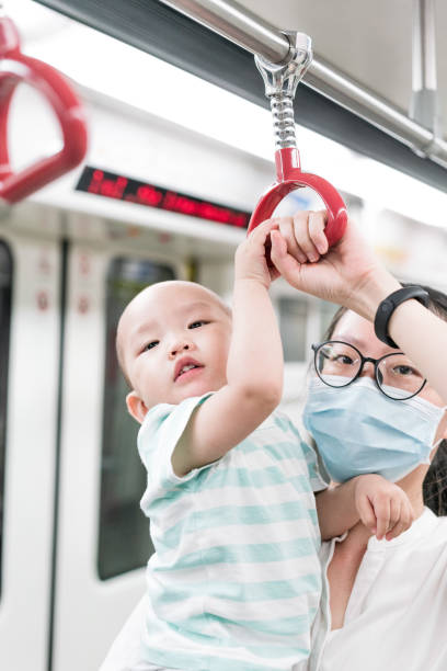 istock Asian mothers take their children on the subway 1273447174