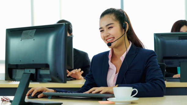 istock Business people wearing headset working in office 1273448293
