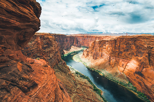 Dramatic landscape at the Grand Canyon National Park where the Colorado River runs through rock formations of eroded sand stone.