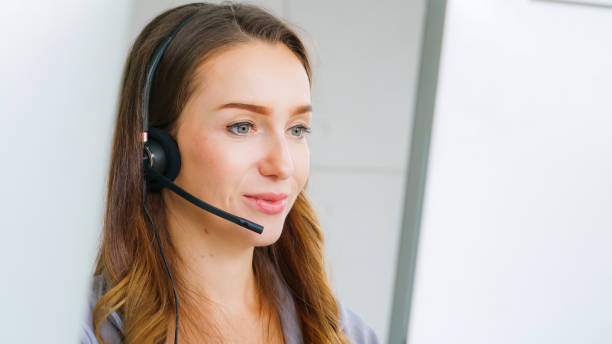 istock Business people wearing headset working in office 1273455499