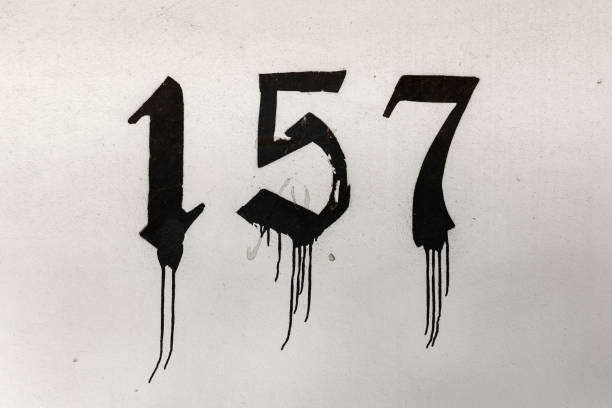 istock number 157 painted in old letter with black paint at a wall 1273455761