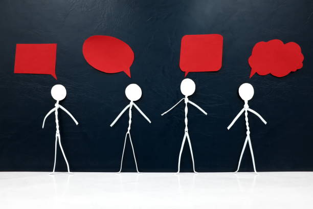 istock Human stick figure with diverse shape red speech bubbles in dark background. Freedom of expression, individuality and diversity in opinion, ideas and thoughts. 1273455763