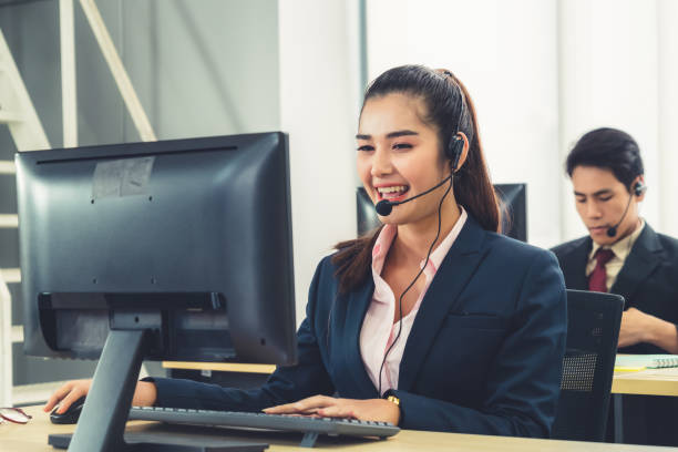 istock Business people wearing headset working in office 1273455891