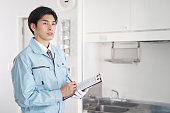 Japanese male worker checking the equipment in the room