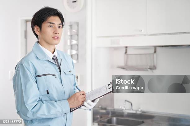 Japanese Male Worker Checking The Equipment In The Room Stock Photo - Download Image Now