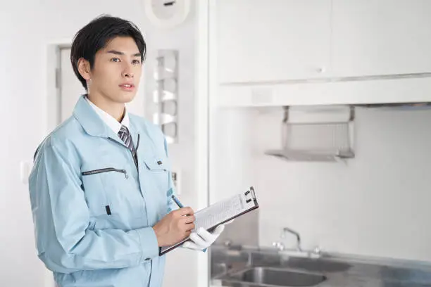 Japanese male worker checking the equipment in the room