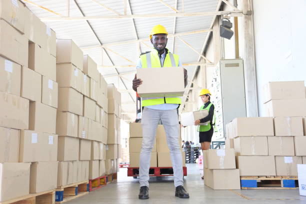 istock African American warehouse worker carry the cardboard box package for shipping 1273458896