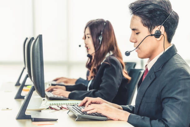 istock Business people wearing headset working in office 1273460902