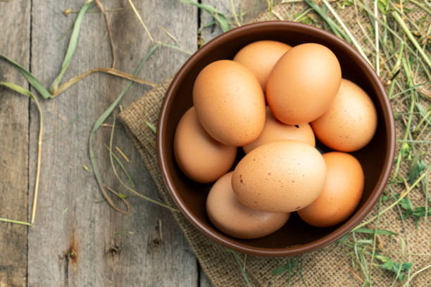 istock Fresh chicken eggs in a clay bowl on the hay. 1273460963