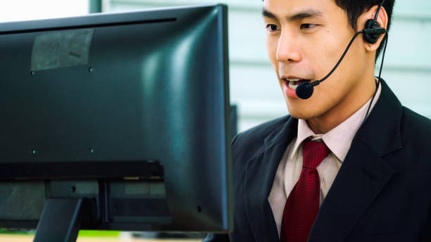 istock Business people wearing headset working in office 1273461367