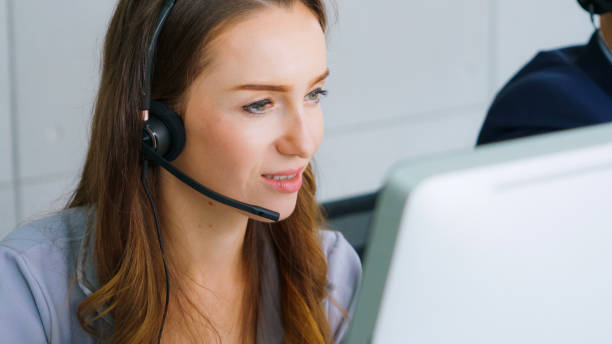 istock Business people wearing headset working in office 1273461910