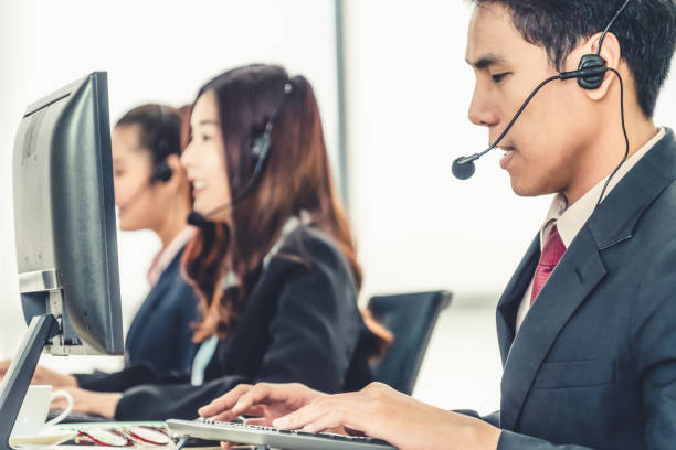 istock Business people wearing headset working in office 1273461959
