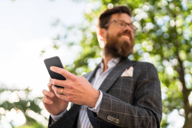 istock Entrepreneur with smart phone looking away 1273462550