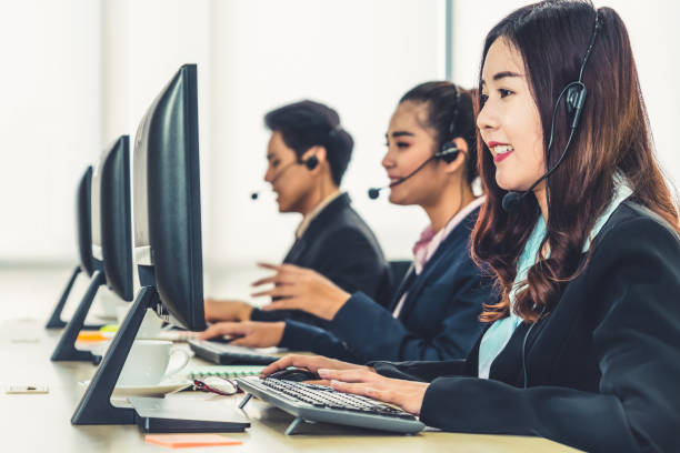 istock Business people wearing headset working in office 1273463159