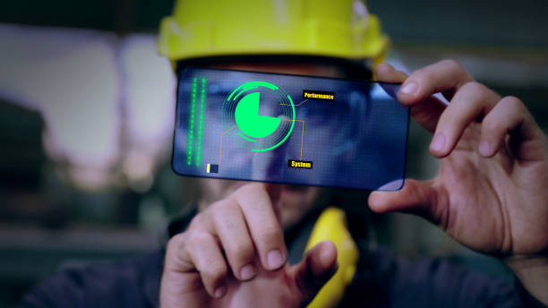 istock Factory worker use future holographic screen device to control manufacturing 1273464864