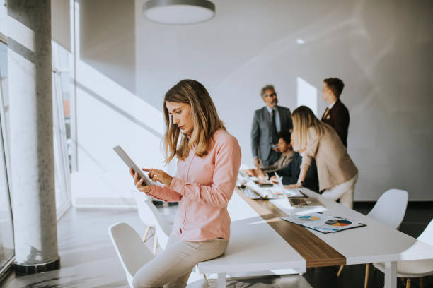 istock Young business woman using digital tablet in the office 1273464872