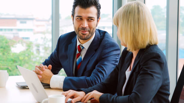istock Two business people talk project strategy at office 1273465667