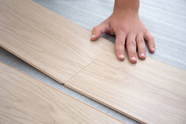 istock male hands intalling wood flooring 1273467971