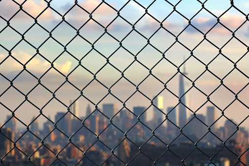 Worldwide coronavirus pandemic. quarantine. New York city behind steel mesh wire fence .Flight ban and closed borders for tourists and travelers in America.