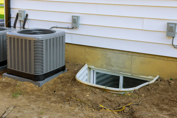 istock Air conditioning system assembled on performing preventive maintenance on window well for basement construction new residential home 1273470428